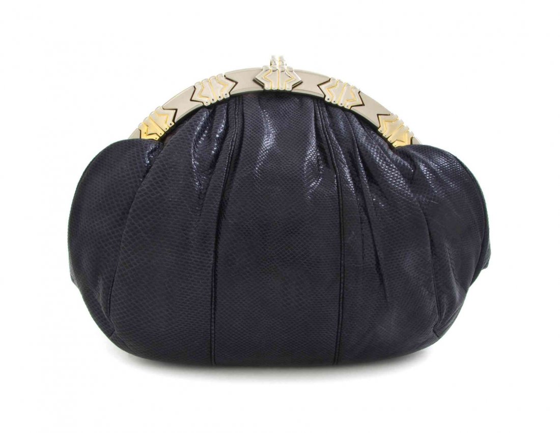 A Judith Leiber Navy Blue Karung Snakeskin Bag, 10 x 8: A Judith Leiber Navy Blue Karung Snakeskin Bag, with a circular goldtone geometric detailed frame and clasp, drop-in snakeskin strap, interior slip and zippered pockets. Stamped: Judith Leiber. 10 x 8