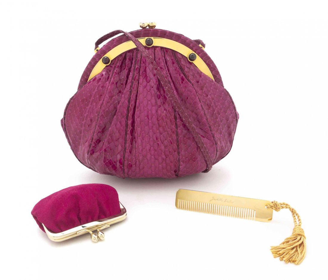 A Judith Leiber Magenta Snakeskin Clutch Purse, 7 1/2 x: A Judith Leiber Magenta Snakeskin Clutch Purse, goldtone push down clasp, drop-in snakeskin strap, interior slip pocket, together with a comb and coin purse. Stamped: Judith Leiber. 7 1/2 x 7 x 3 1/2