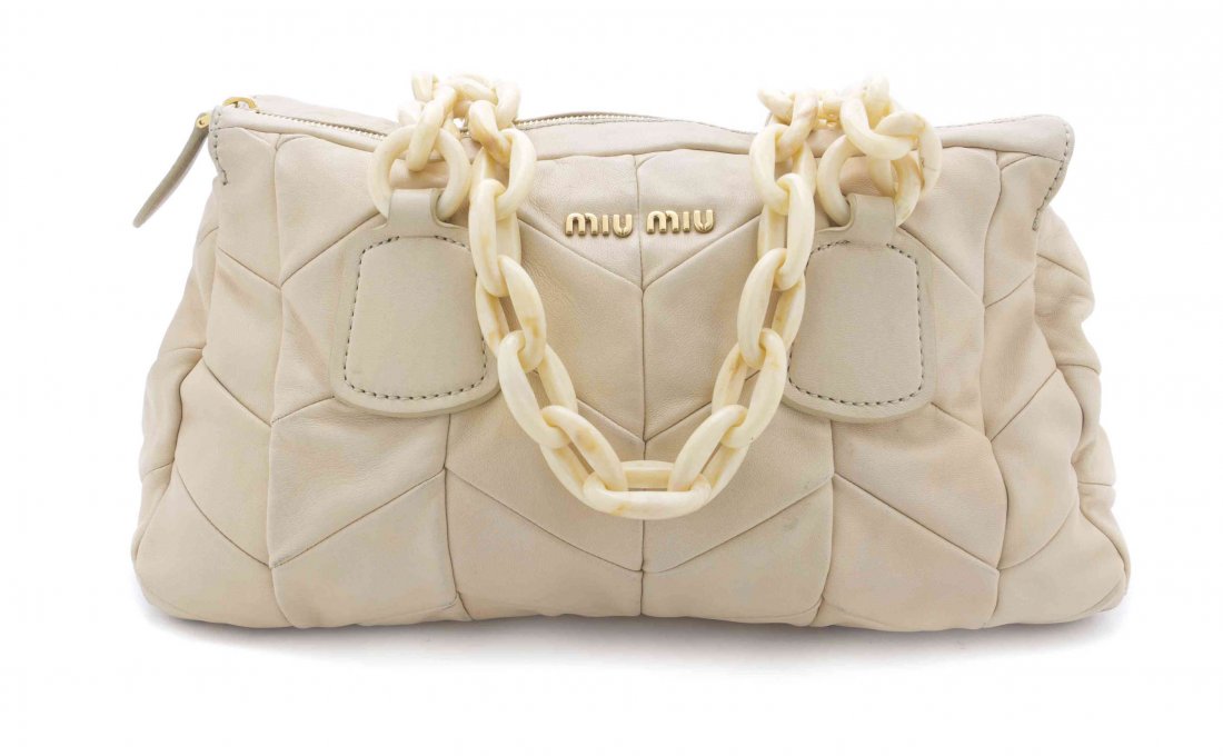 A Miu Miu Ivory Chevron Quilted Leather Bag, 15 x 8 x 5: A Miu Miu Ivory Chevron Quilted Leather Bag, with resin chain strap, goldtone zip top and interior zippered pocket. Stamped: Miu Miu. 15 x 8 x 5 1/4 inches. Property from a Private Collector, Chicago,