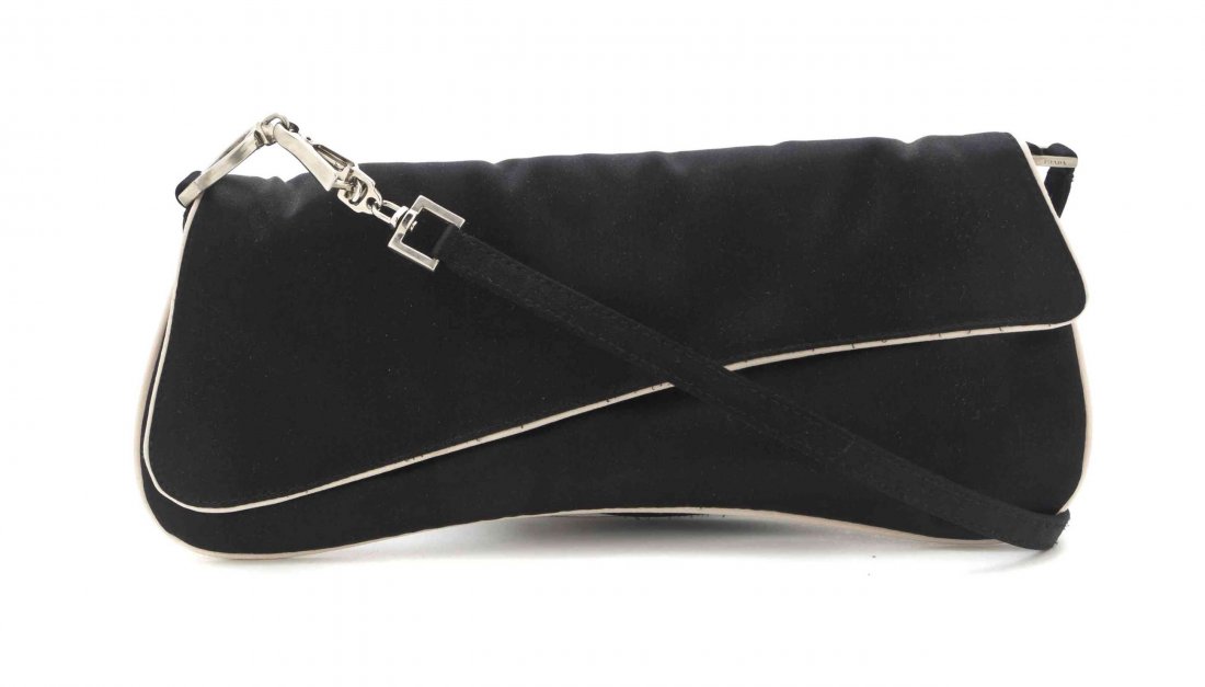 A Prada Black Satin and White Trim Clutch, 10 x 4: A Prada Black Satin and White Trim Clutch, single shoulder strap, foldover flap with button clasp, exterior and interior slip pockets. Stamped: Prada. 10 x 4 inches.