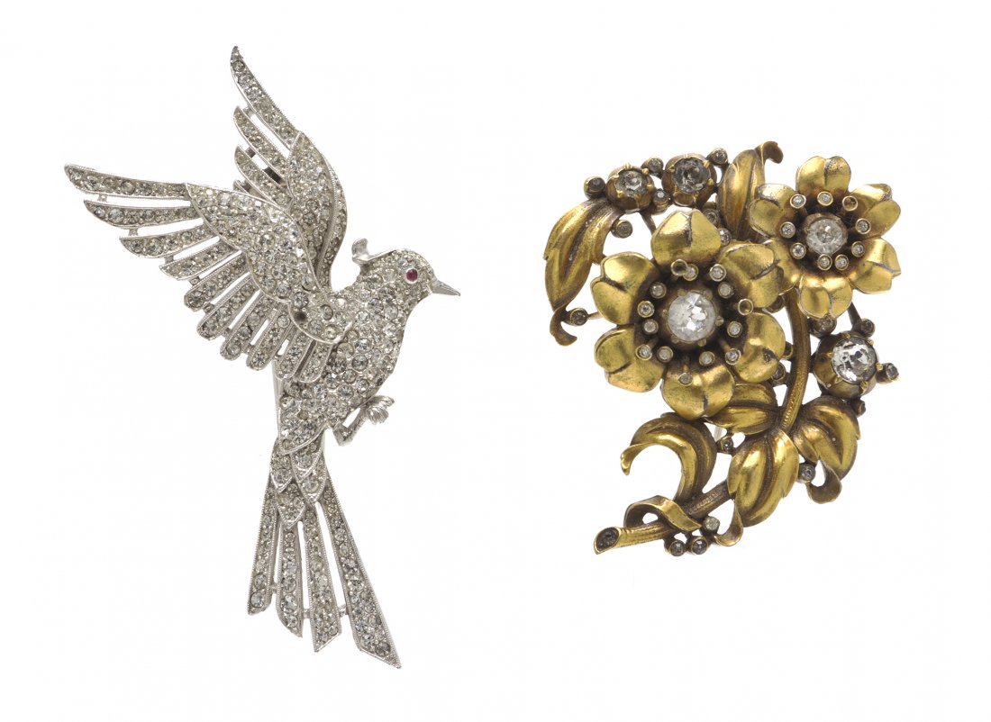 A Pair of Trifari Fur Clips,: A Pair of Trifari Fur Clips, comprised of a silvertone rhinestone bird clip, together with a goldtone rhinestone flower clip. Stamped:Trifari.