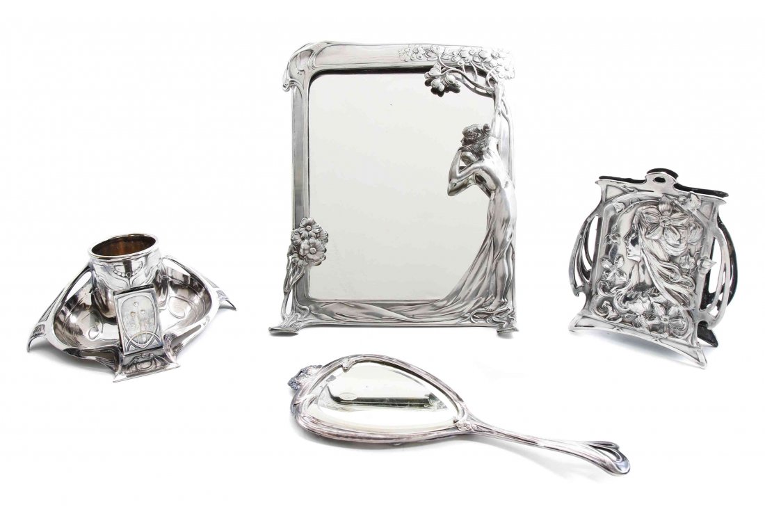 Four Art Nouveau Dresser and Table Articles, Height of: Four Art Nouveau Dresser and Table Articles, comprising a pewter rectangular dressing table mirror, the frame decorated with a girl by a tree, and three silver-plate items, two by WMF, including a han