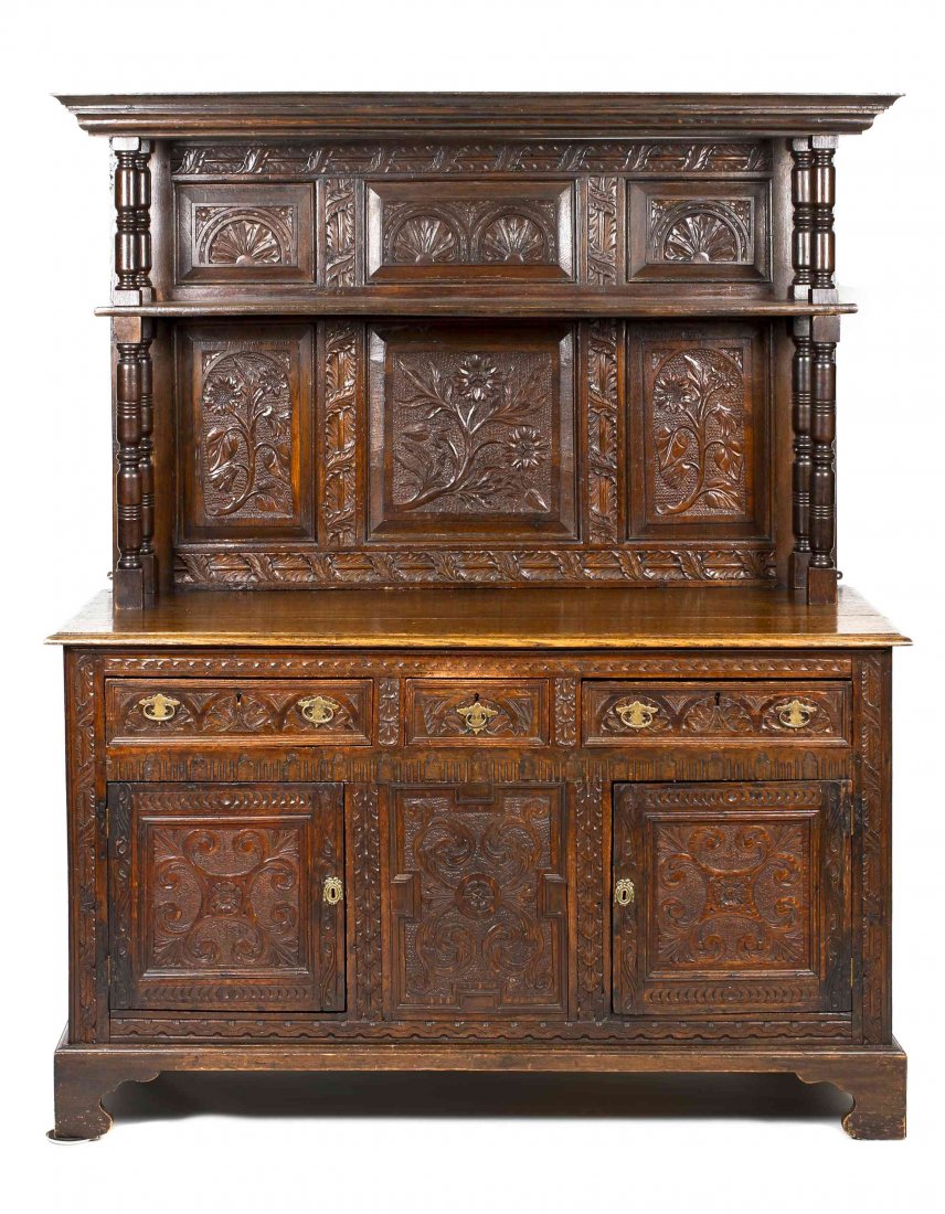 A Renaissance Revival Carved Oak Sideboard, Height 76 x: A Renaissance Revival Carved Oak Sideboard, in two parts, the upper section with flat cornice over shelf raised on turned supports flanking foliate carved panels, the lower section with three drawers 
