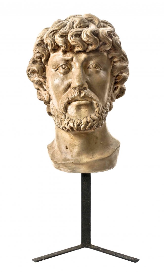 A Plaster Bust of Marcus Aurelius, Height overall 19: A Plaster Bust of Marcus Aurelius, after the Roman statue in the Campidoglio, with white-painted surface, raised on an iron stand. Height overall 19 inches.