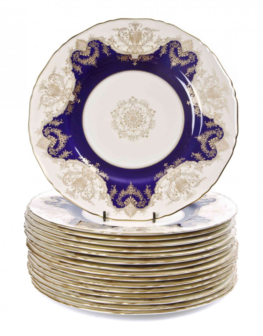 Sixteen Royal Worcester Porcelain Dinner Plates,: Sixteen Royal Worcester Porcelain Dinner Plates, c. 1931-32, printed in gold with urns, garlands and swags, with cobalt blue border. Diameter 10 1/2 inches.
