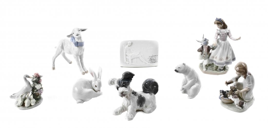 A Collection of Eight Lladro Porcelain Figures, Height: A Collection of Eight Lladro Porcelain Figures, comprising Baby Boy Lamb, Alice in Wonderland, Terrier, Preening Bunny, Polar Bear, Joy in a Basket