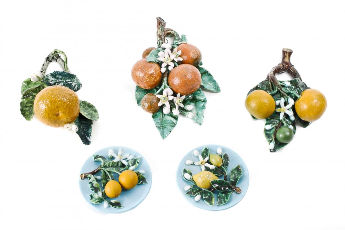 A Collection of Five French Citrus-themed Faience Wall: A Collection of Five French Citrus-themed Faience Wall Hangings, comprising two small turquoise-glazed roundels marked PGM for Perret-Gentil, Menton, two wall pockets formed as oranges on a branch, an