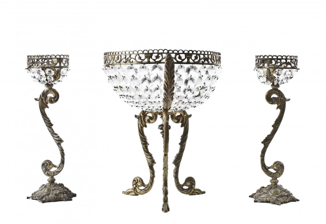 A Three Piece Spanish Brass and Glass Rococo Style: A Three Piece Spanish Brass and Glass Rococo Style Garniture Set, 20th century, comprising a pair of candlesticks with S-scroll stems and foliate bases, and a center bowl with three rocaille scroll le
