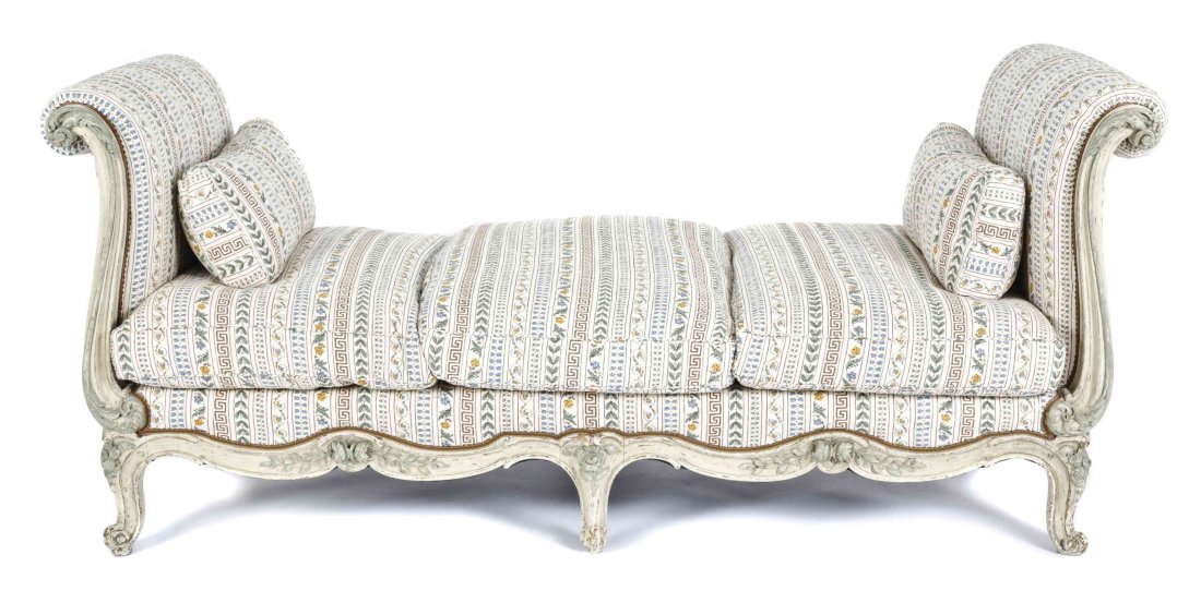 A Louis XV Style Painted Day Bed, Height 34 1/2 x width: A Louis XV Style Painted Day Bed, with outscrolled ends, and floral-carved frame, upholstered in floral printed and quilted cream cotton. Height 34 1/2 x width 34 1/2 x length 82 inches. Property of a
