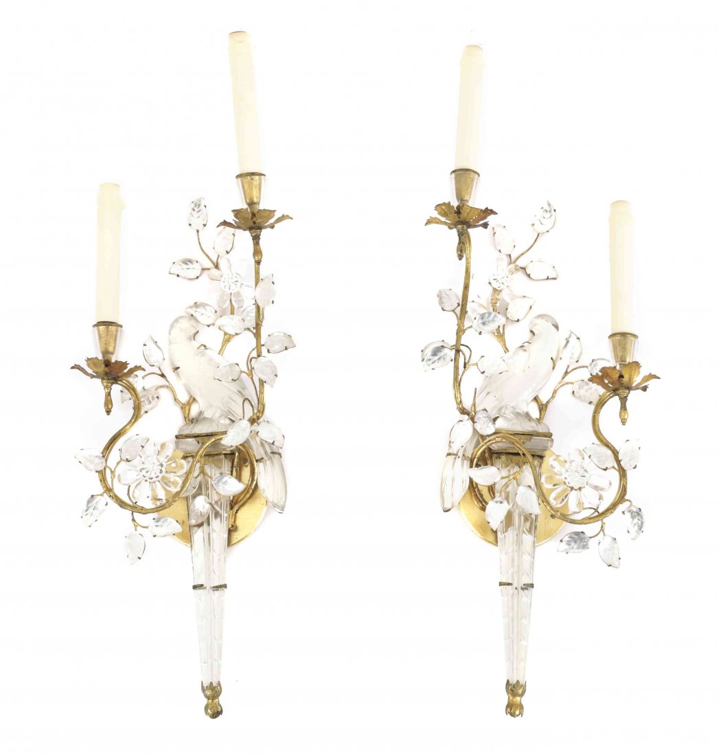 A Pair of French Bronze and Crystal Figural Two-Light: A Pair of French Bronze and Crystal Figural Two-Light Wall Sconces, by Bagues, formed as a parrot atop a torch, with two scrolled foliate candlearms. Length 23 inches. Property of a Palm Beach Estate