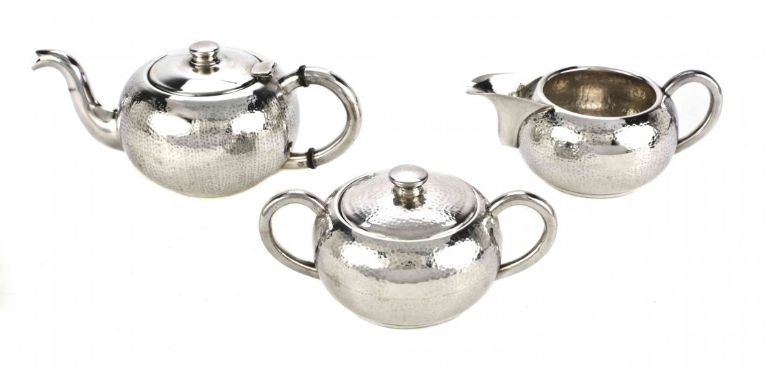 A South American Silver Three-Piece Small Tea Set, 20th: A South American Silver Three-Piece Small Tea Set, 20th Century, comprising a teapot, creamer and covered sugar bowl, the ovoid bodies with spot-hammered surfaces; 22 ozt. Height of teapot 3 inches.