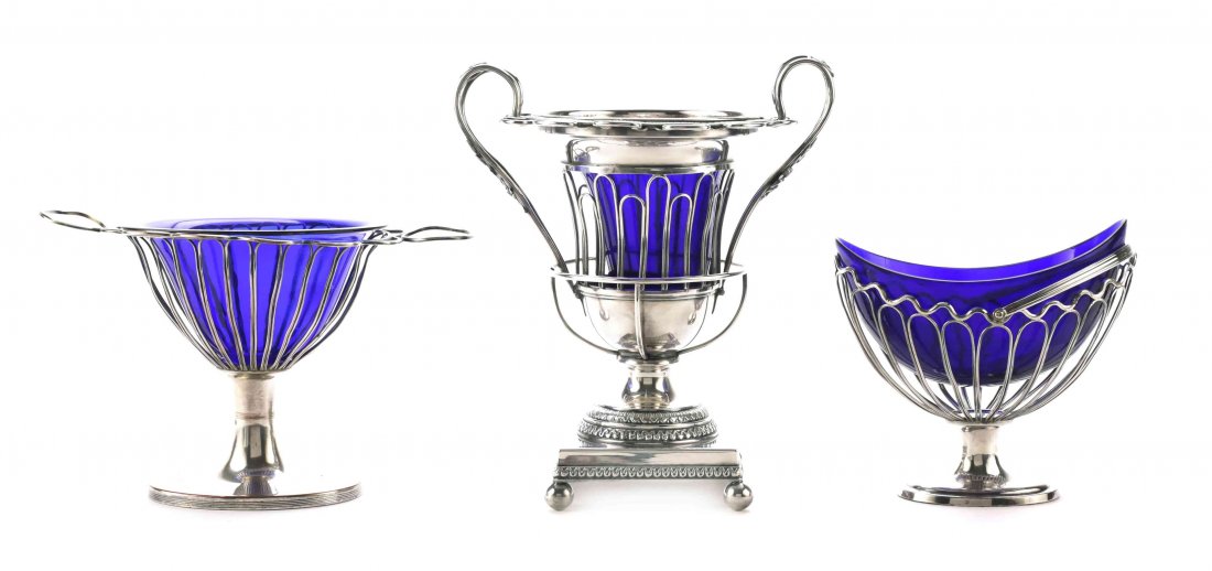 A Group of Three Silver-Plate and Cobalt Glass-Lined: A Group of Three Silver-Plate and Cobalt Glass-Lined Sugar Baskets, Late 18th/Early 19th Century, comprising two English Sheffield plate, both ovoid with wirework bodies, one with swing handle, the ot