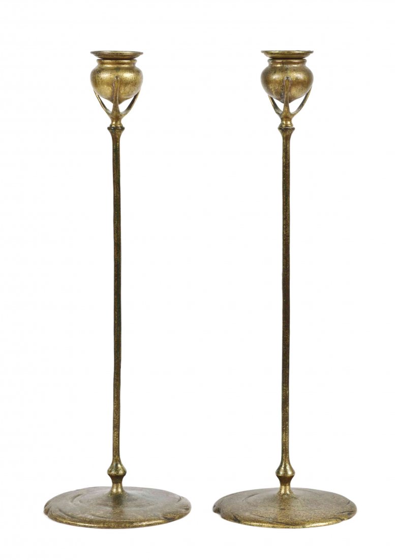 A Pair of Tiffany Studios Dore Bronze Candlesticks,: A Pair of Tiffany Studios Dore Bronze Candlesticks, each candlecup of baluster form supported by three prongs, over a tapering standard, raised on a circular foot, stamped Tiffany Studios New York, nu