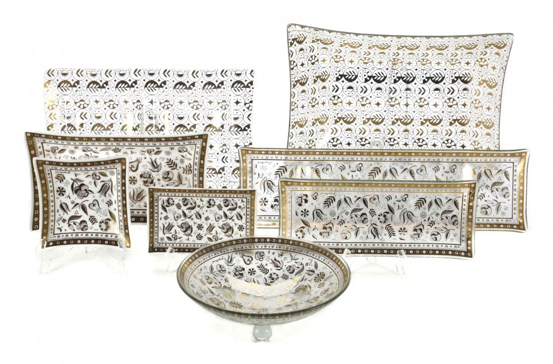 A Collection of Georges Briard Table Articles, Length: A Collection of Georges Briard Table Articles, comprising eight glass platters and serving dishes, two glass serving bowls, a Pyrex entree dish on a gilt metal warming stand, five graduated tole platt