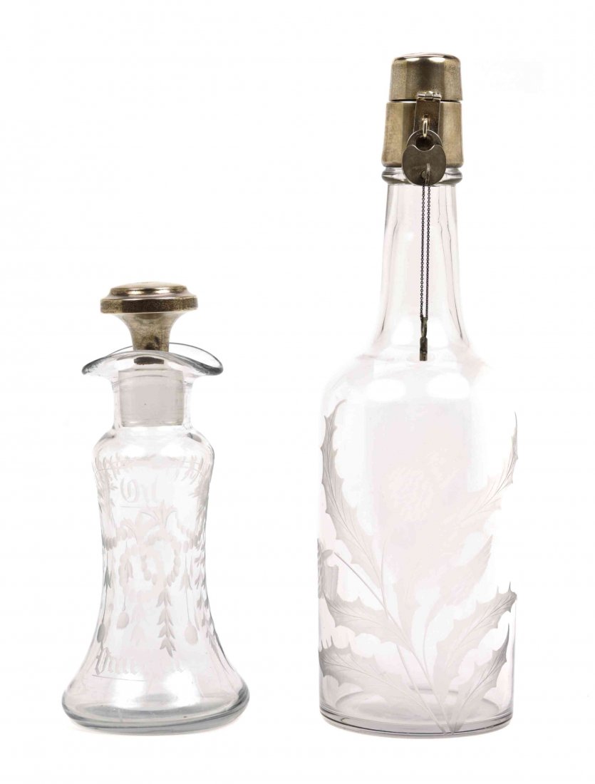 A Pair of Cut Glass and Silver Bottles. Height of: A Pair of Cut Glass and Silver Bottles. Height of taller 12 inches. Property of a Lady, Philadelphia and Palm Beach