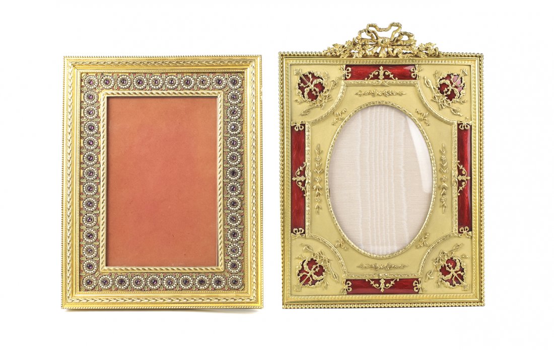 Two French Gilt Metal Decorative Picture Frames, Larger: Two French Gilt Metal Decorative Picture Frames, 20th century, rectangular with easel supports, one with round bosses inset with purple pastes, the other with garland to top and red guilloche enamel f
