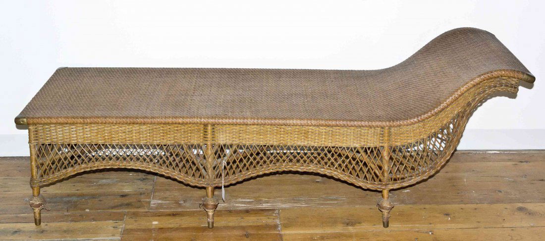 A Victorian Style Wicker Chaise Lounge, Length 74 x: A Victorian Style Wicker Chaise Lounge, having an undulating apron over six toupie feet. Length 74 x width 27 inches.