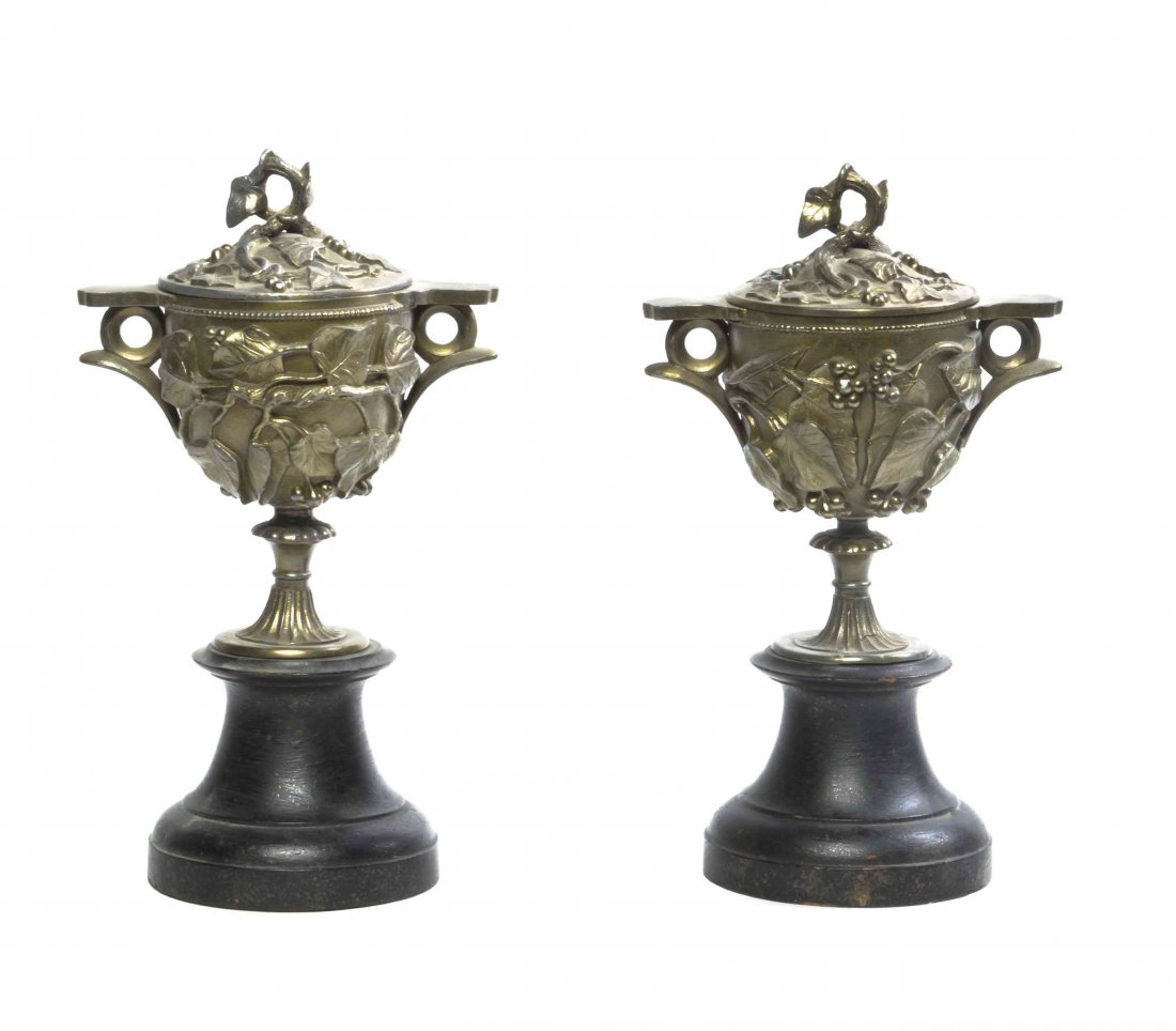 A Pair of Continental Gilt Metal Urns, Height 13: A Pair of Continental Gilt Metal Urns, having a lift off cover, worked to show grapevines throughout, raised on an ebonized wood base. Height 13 inches.