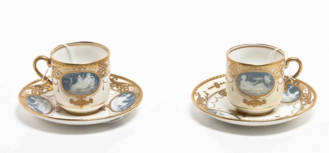 A Pair of Minton Pate-sur-Pate Cabinet Cups and: A Pair of Minton Pate-sur-Pate Cabinet Cups and Saucers, each decorated with classical reclining figures with gilt highlights. Diameter of saucers 5 inches.