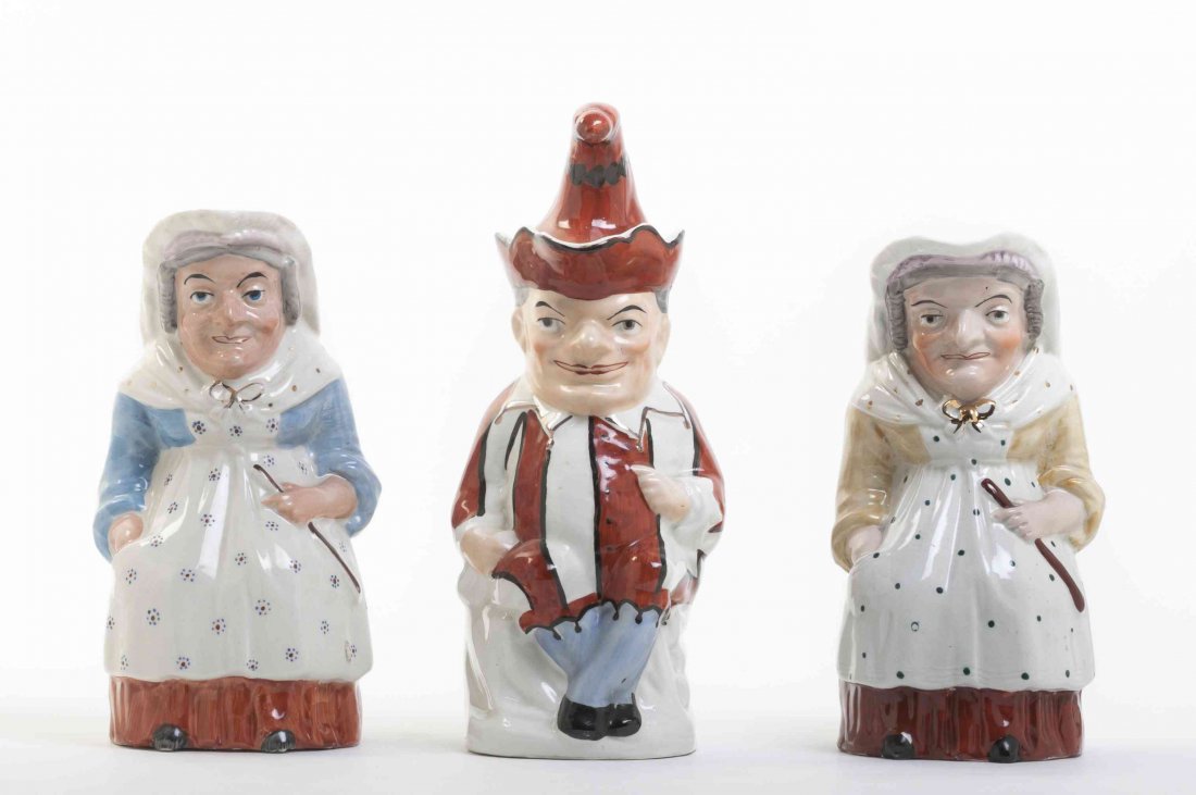 Three Ceramic Toby Jugs, Height of tallest 12 inches.: Three Ceramic Toby Jugs, depicting Punch with a lidded hat, Judy in a yellow dress and Judy in a blue dress. Height of tallest 12 inches.