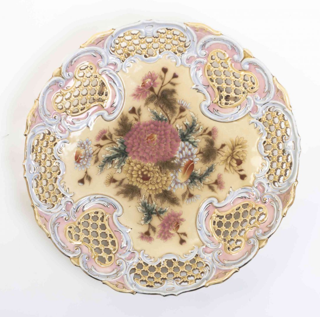 A Zsolnay Porcelain Platter, Diameter 14 7/8 inches.: A Zsolnay Porcelain Platter, of circular form having a shaped and reticulated border, centrally painted to show a floral spray. Diameter 14 7/8 inches.