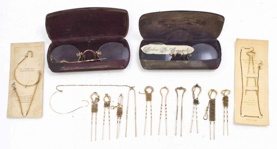 A Group of Twelve Gilt Metal and Gold Filled Lorgnette: A Group of Twelve Gilt Metal and Gold Filled Lorgnette Hairpin Chains, together with two lorgnettes, one having its own hairpin chain. Length of longest hairpin 2 5/8 inches. Property from the Collect