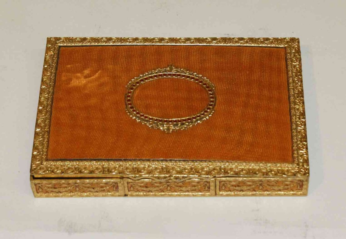 An Italian Gilt Metal and Guilloche Enamel Box, Width 5: An Italian Gilt Metal and Guilloche Enamel Box, having a hinged rectangular lid cast with swag and foliate decoration throughout. Width 5 1/2 inches.