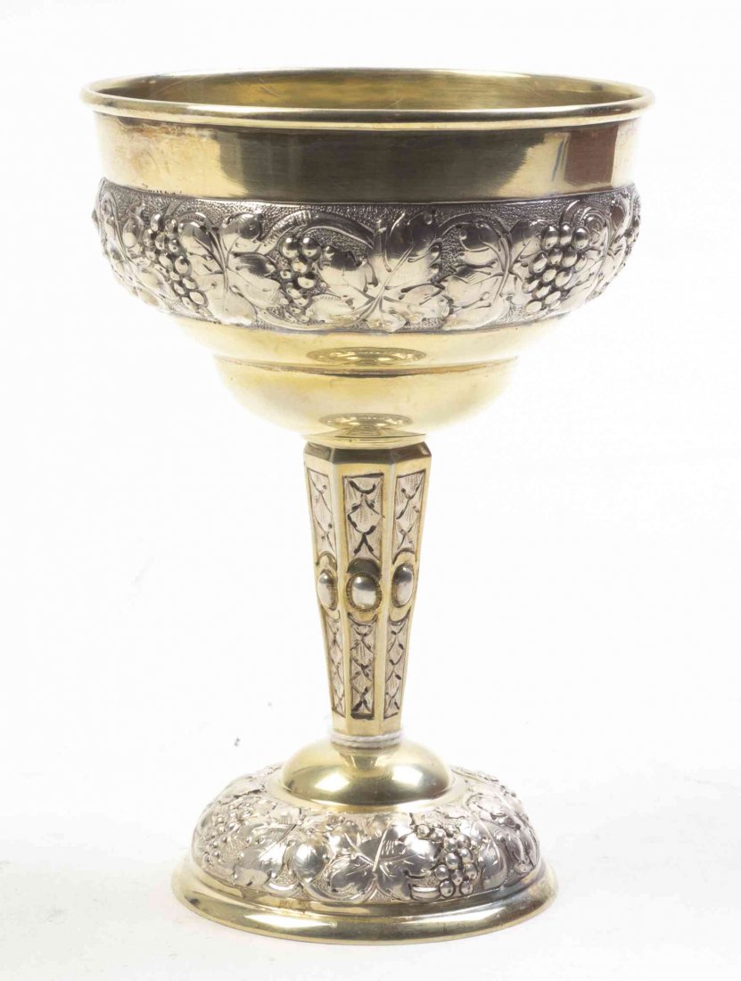A German Silver Gilt Cup, Height 5 1/8 inches.: A German Silver Gilt Cup, with bands of foliate and grape decoration, marked 800, M.A. in a heart; 3 ozt 13 dwt. Height 5 1/8 inches.