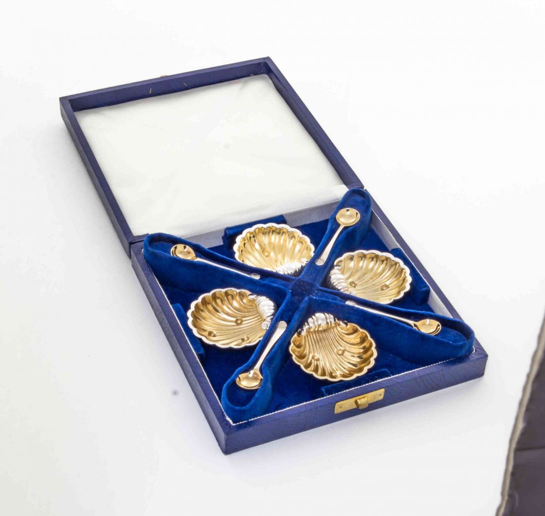 A Cased Set of Four Elizabeth II Silver Salts and: A Cased Set of Four Elizabeth II Silver Salts and Spoons, Alfred E. Jones, Birmingham, Early 20th Century, each of shell form, bowls with gilt decoration; 2 ozt 8 dwt. Length 1 1/2 inches.