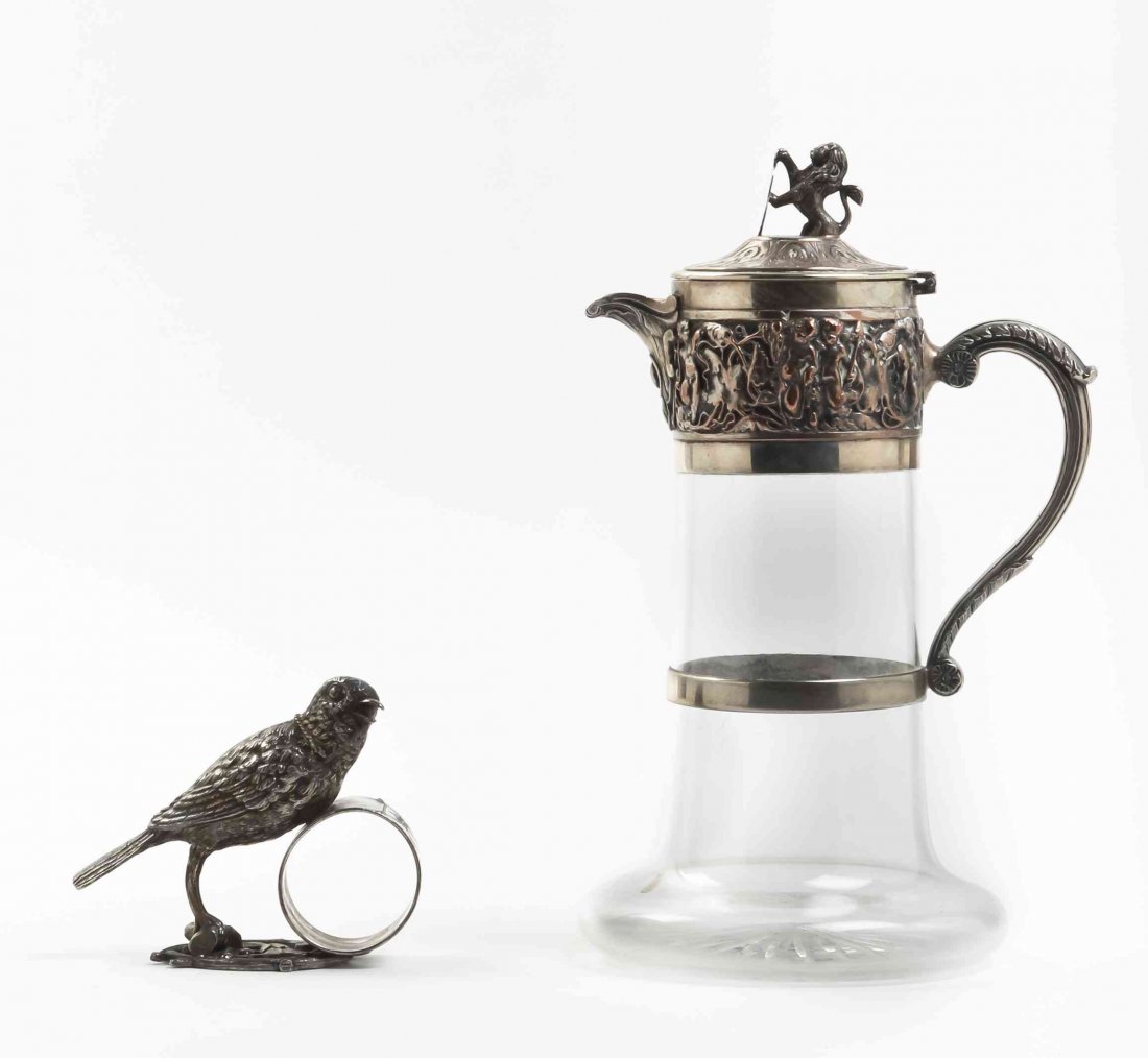Two Silver-Plate Table Articles, Late 19th Century,: Two Silver-Plate Table Articles, Late 19th Century, comprising a glass decanter with silver-plate mounts decorated with a band of putto and surmounted by a lion finial, and a fully modeled bird-form n