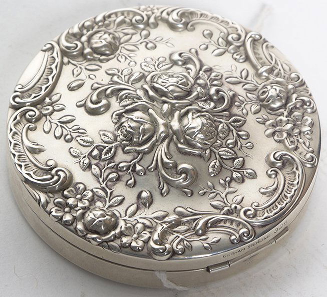 An American Silver Compact, Gorham Mfg. Co.,: An American Silver Compact, Gorham Mfg. Co., Providence, RI, 20th Century, of circular form with repousse rose decoration, mirror interior, marked Gorham Sterling 325. Diameter 3 inches.