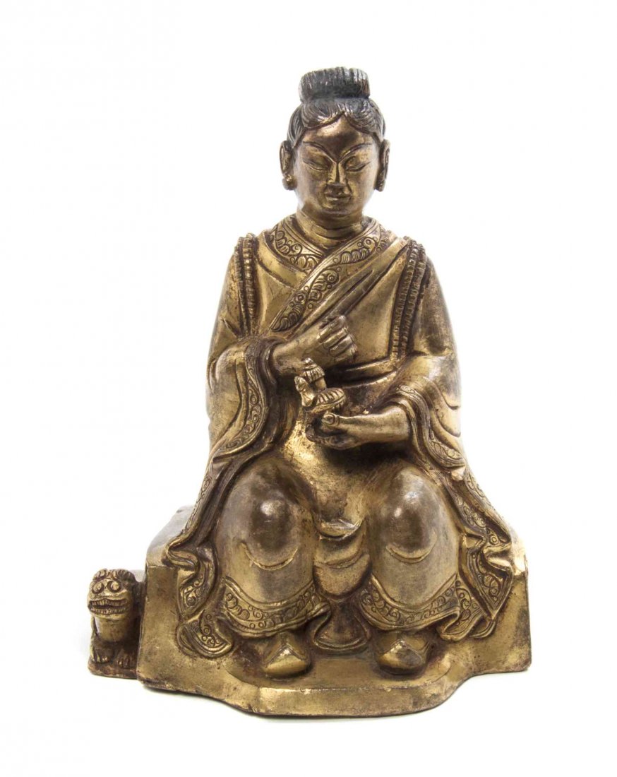 A Chinese Gilt Bronze Figure of a Lady, Height overall: A Chinese Gilt Bronze Figure of a Lady, the lady depicted seated in draped robes, holding a ewer with a fu lion crouched beside her seat. Height overall 4 7/8 inches.