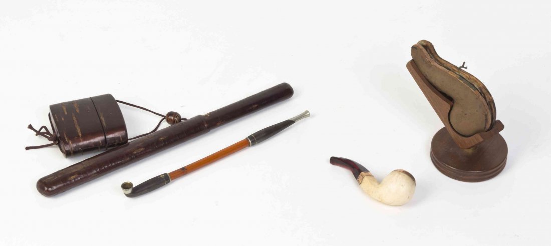 A Group of Smoking Articles, Length of first 11 3/4: A Group of Smoking Articles, comprising a lacquered inro with a pipe case and a bamboo and mixed metal pipe, having a turned wood ojime with a meerschaum and amber cased pipe on stand. Length of first