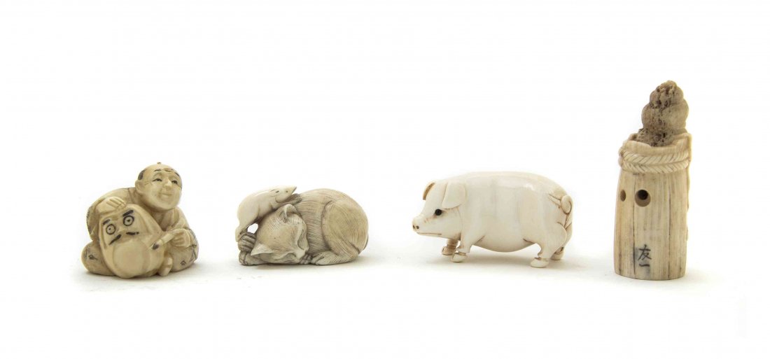 A Group of Four Japanese Carved Ivory Netsuke, Height: A Group of Four Japanese Carved Ivory Netsuke, one depicting a pig, one a sleeping cat with a rat and two other examples. Height of tallest 2 5/16 inches.