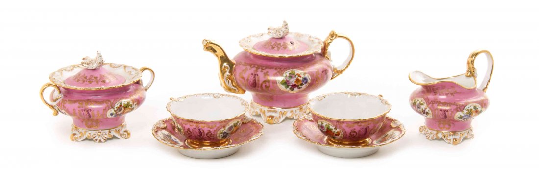 A Jacob Petit Porcelain Tete-a-Tete, Width of teapot 7: A Jacob Petit Porcelain Tete-a-Tete, comprising a teapot, a covered sugar, a creamer, two cups and two saucers, each having polychrome foliate sprays on a pink ground, each bearing JP mark. Width of t