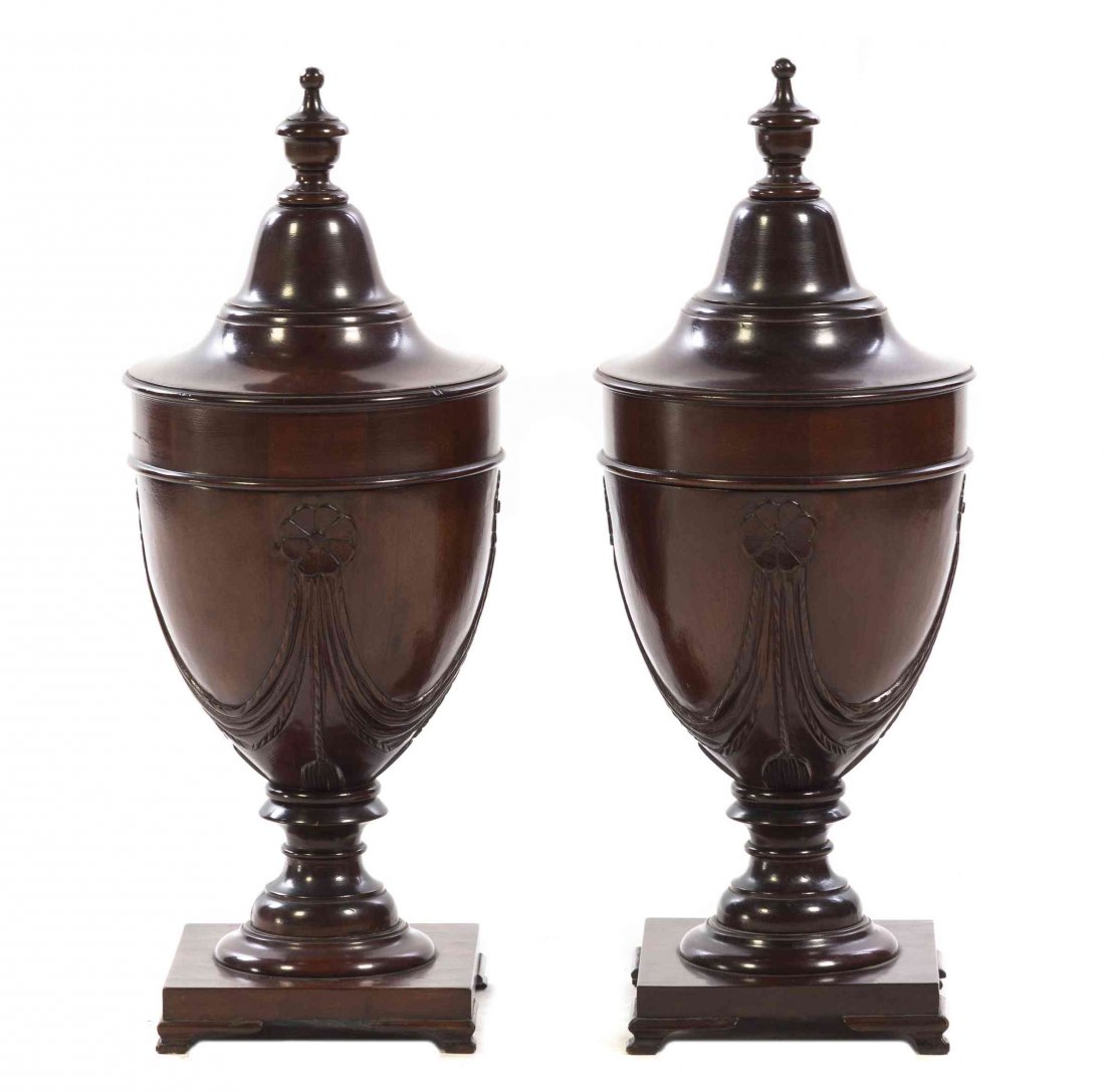 A Pair of Georgian Style Mahogany Cutlery Urns, Height: A Pair of Georgian Style Mahogany Cutlery Urns, with baluster form finials, the bodies with floral and swag decoration opening to a fitted interior, raised on square bases with slightly flared feet. H