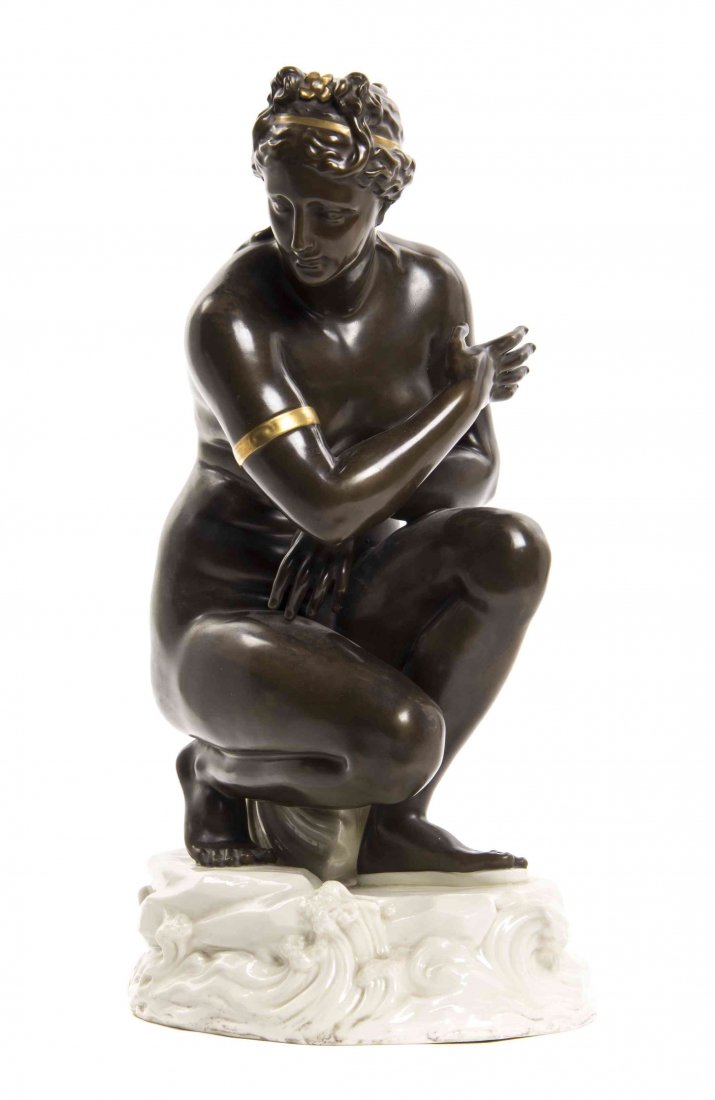 A Belleek 'Bronzed' and Gilt Decorated Crouching Venus,: A Belleek 'Bronzed' and Gilt Decorated Crouching Venus, 1863-1890, depicted with a gilt head and arm bands, seated on a shell on a wave crested rockery base, impressed Belleek Co. Fermanagh and with f