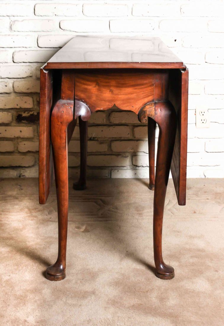 A Queen Anne Mahogany Drop-Leaf Table, Height 27 1/4 x: A Queen Anne Mahogany Drop-Leaf Table, having rectangular top and leaves above the shaped skirts, raised on cabriole legs. Height 27 1/4 x width 42 1/2 x depth 16 1/2 inches (closed).