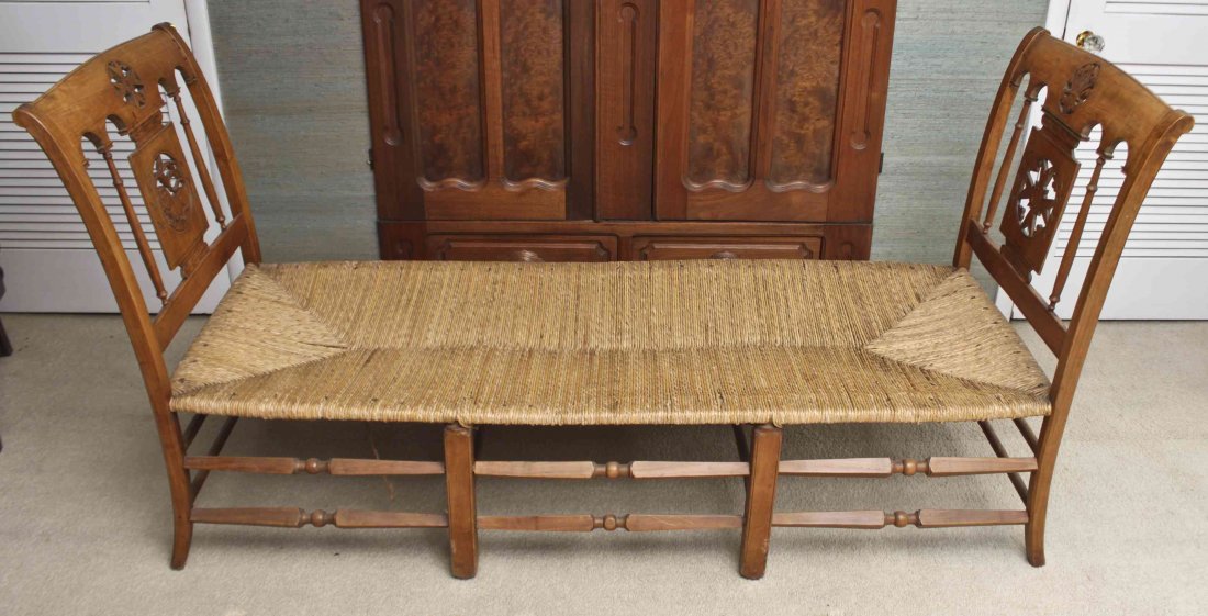 A Fruitwood Neoclassical Daybed, Width 81 inches.: A Fruitwood Neoclassical Daybed, each out swept arm with pierce carved Maltese cross palmette or lion pierce carved decoration over the woven seat raised on slightly splayed legs joined by double stre