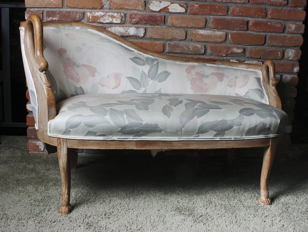 An Empire Mahogany Settee, Height 31 x width 49 x depth: An Empire Mahogany Settee, having a shaped back with swan neck handles above a stuffover cushion seat raised on shaped legs, ending in hairy paw feet. Height 31 x width 49 x depth 26 inches.