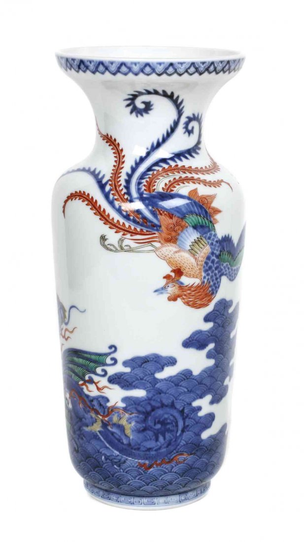 A Japanese Porcelain Vase, Height 10 1/4 inches.: A Japanese Porcelain Vase, of baluster form decorated with a phoenix and a dragon amidst clouds, bearing underglaze blue leaf mark to the underside. Height 10 1/4 inches.