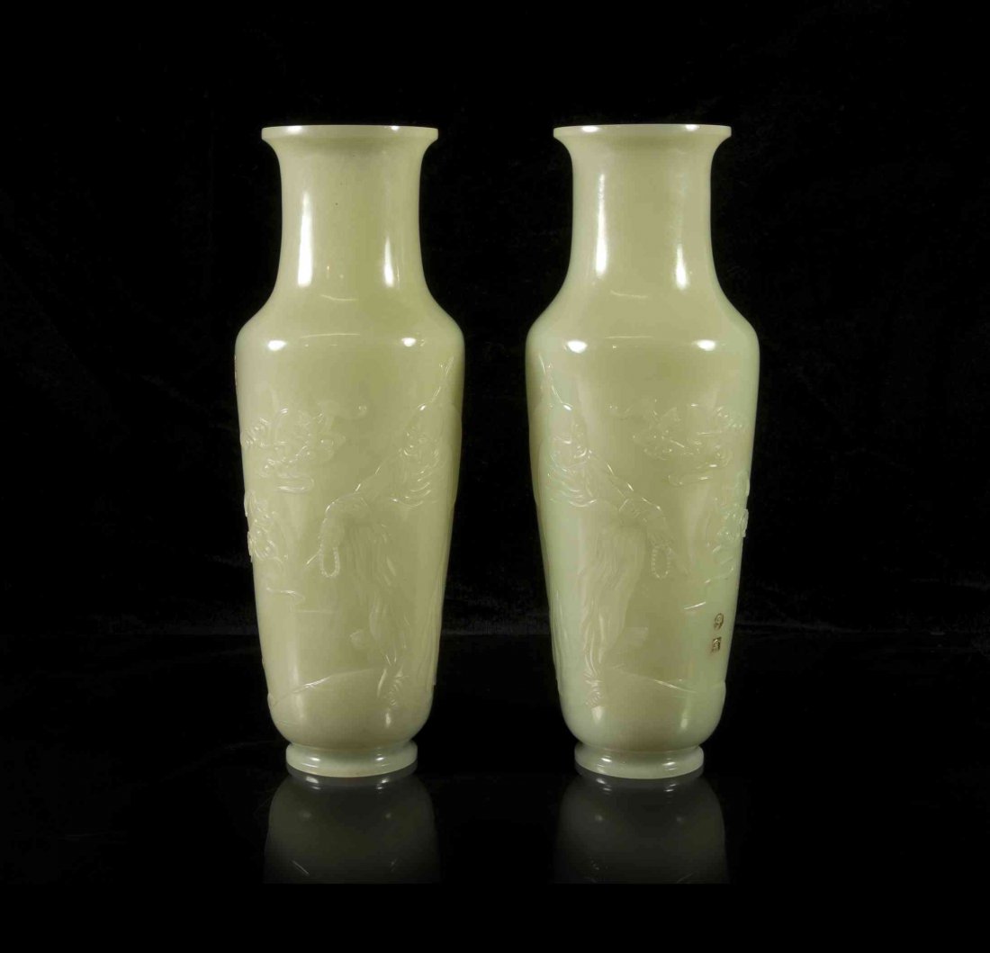 A Pair of Carved Jade Baluster Vases, Height 8 inches.: A Pair of Carved Jade Baluster Vases, each of a celadon colored stone, carved with luohan in high relief to the sides, the Jin Gang Buddhist sutra carved and picked out in gilt paint, bearing carved a