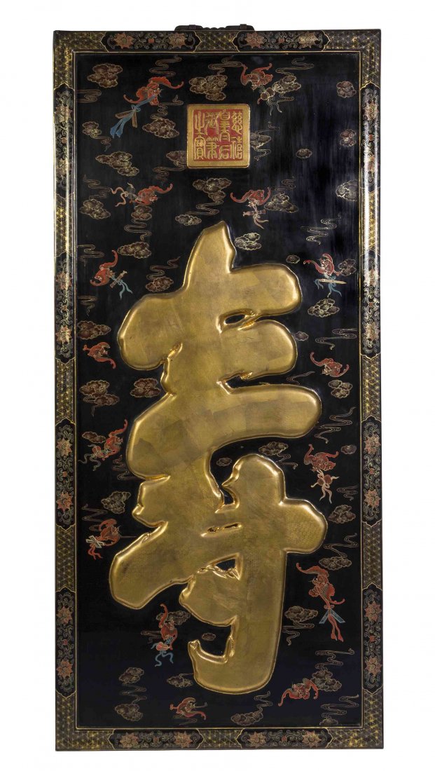 A Chinese Lacquered Shou Panel, Height 87 x width 40: A Chinese Lacquered Shou Panel, of rectangular form, depicting the shou character in gilt paint against a field of painted bats and ruyi clouds against a black lacquer ground, framed. Height 87 x widt