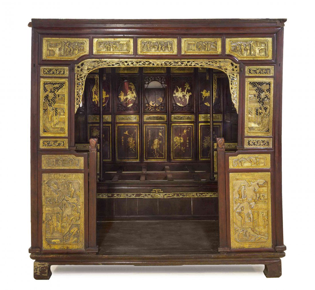 A Chinese Gilt Paint and Red Lacquer Opium Bed, Height: A Chinese Gilt Paint and Red Lacquer Opium Bed, late Qing Dynasty, having an antechamber preceding the bed with relief carved and gilt painted panels, the antechamber raised on a bracket base with car