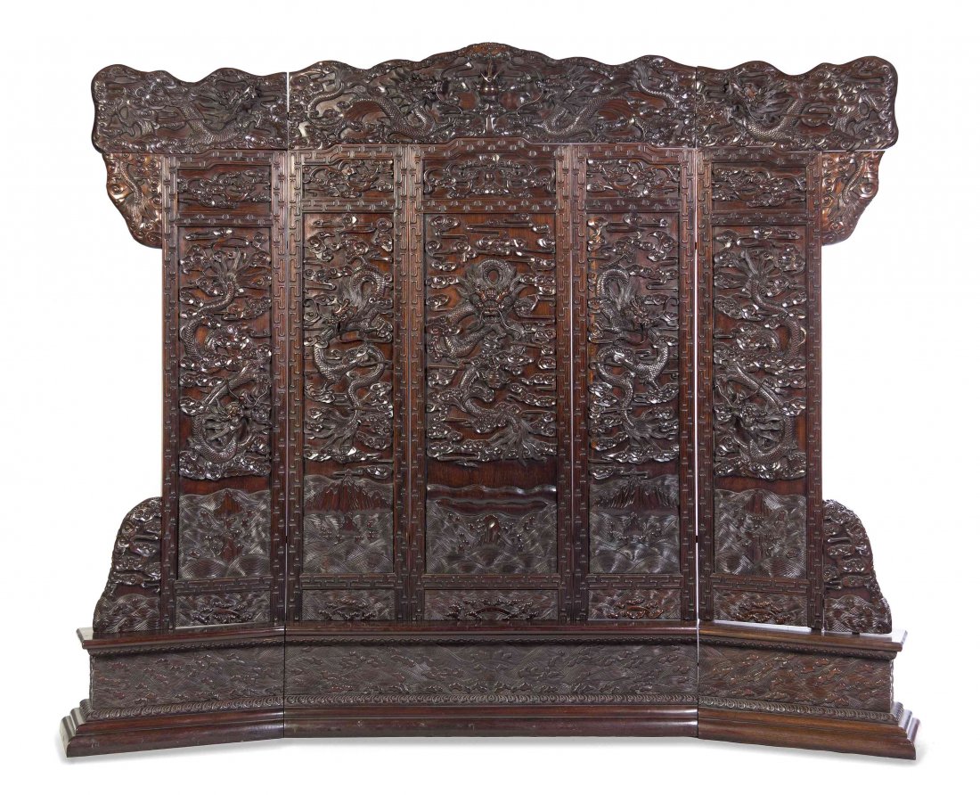 A Chinese Carved Hardwood Five-Panel Screen, Height 88: A Chinese Carved Hardwood Five-Panel Screen, having relief carved dragon decoration throughout. Height 88 x width 103 x depth 10 1/4 inches. Property from a Prominent Midwest Collection