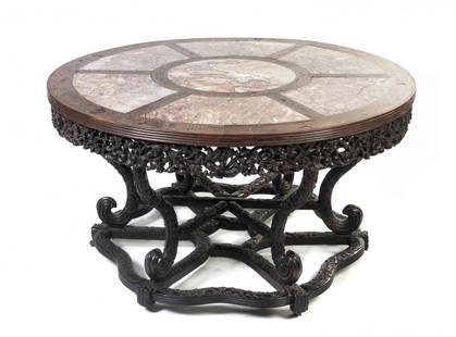 A Chinese Carved Hardwood, Marble and Brass Inset: A Chinese Carved Hardwood, Marble and Brass Inset Center Table, the circular top inset with segmented marble elements, further inlaid with scrolling brass decoration over the pierced carved frieze, ra