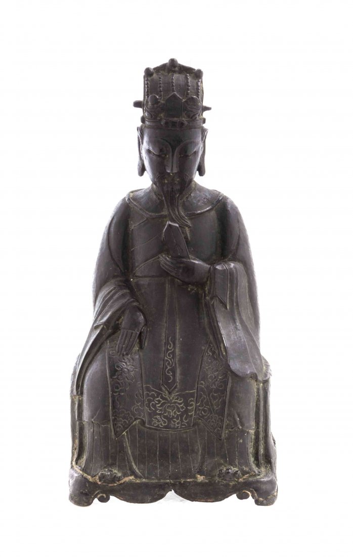 A Chinese Bronze Figure of an Official, Height 11 3/4: A Chinese Bronze Figure of an Official, Ming Dynasty, the figure depicted seated with a peaked headdress centered with Wang, having a long beard and downcast gaze, holding a tablet in one hand, the ot
