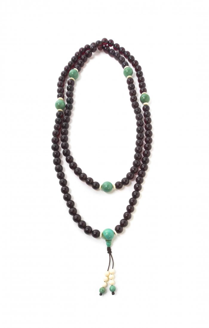 A Strand of Amber Buddhist Mala Prayer Beads, Length 62: A Strand of Amber Buddhist Mala Prayer Beads, comprising 108 round amber beads, the material of translucent, rich burgundy color and interspersed with round turquoise spacer beads. Length 62 inches, d