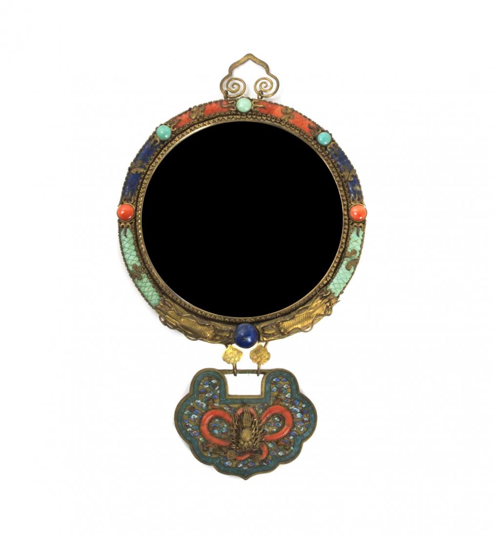 A Sino-Tibetan Framed Mirror, Height overall 15 inches.: A Sino-Tibetan Framed Mirror, of circular form, having lapis, turquoise and coral inlay, with a ruyi form enameled and filigree pendant, having gilt metal mounts, the reverse with shou and Buddhist ba