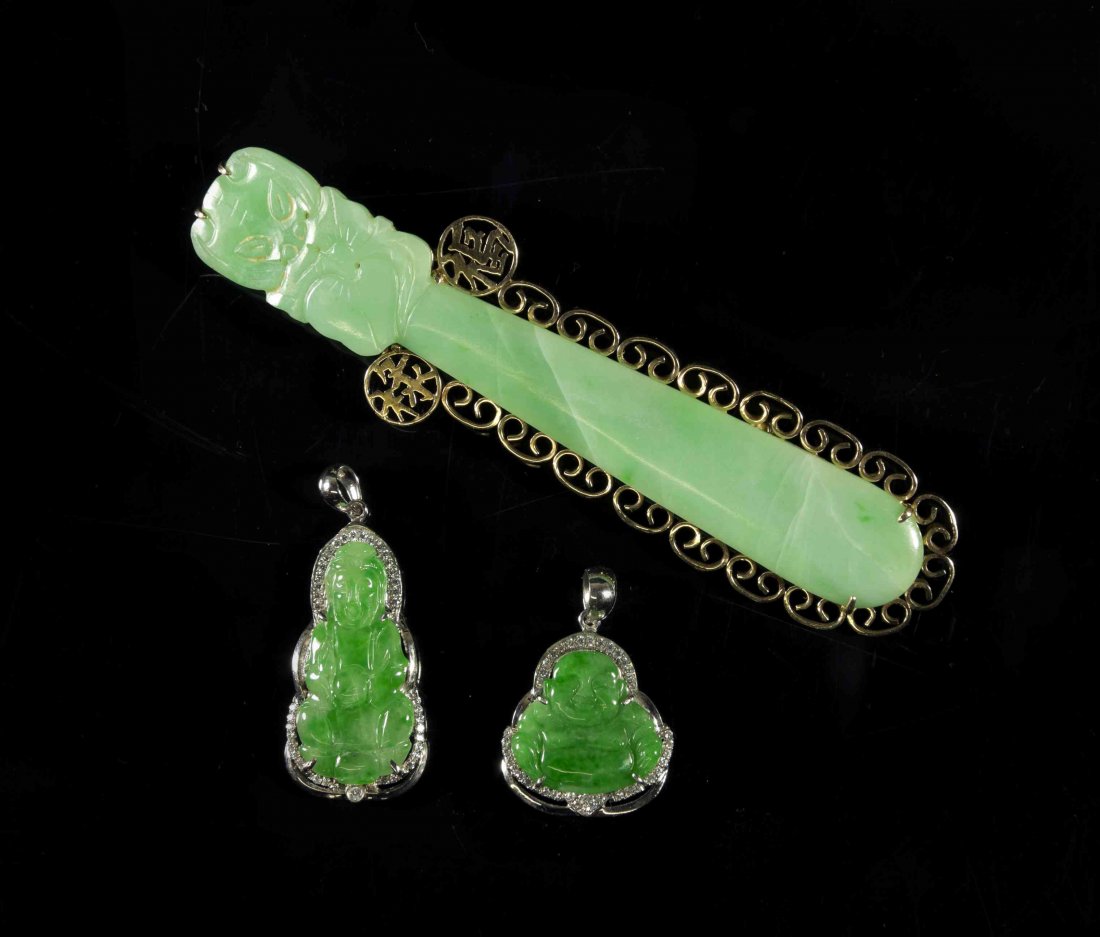 Three Jade Mounted Jewelry Articles, Height of tallest: Three Jade Mounted Jewelry Articles, comprising an apple green jade hair ornament mounted in 14k yellow gold as a brooch, with two green jade Buddhist pendants. Height of tallest 3 3/4 inches. Propert